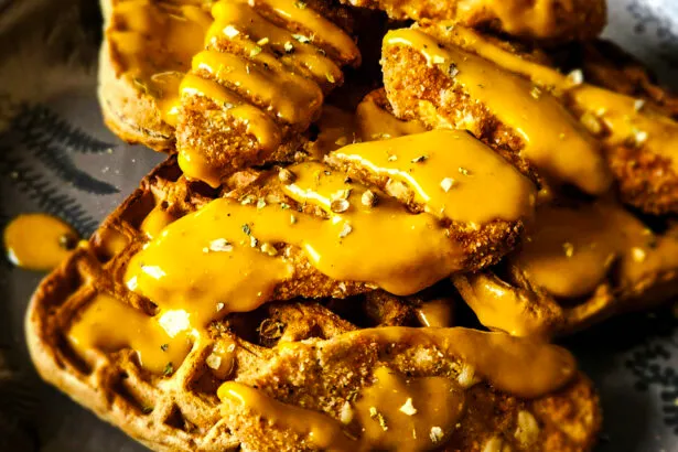 A delicious plant-based dish with crispy vegan chick'n tenders on top of whole grain waffles, drizzled with a zesty maple sriracha mustard sauce.